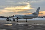 Maintenance specialists for the Wisconsin Air National Guard's RC-26B reconnasance aircraft tow it into an aircraft ramp at Dane County Regional Airport following it's final flight Dec. 28, 2022.