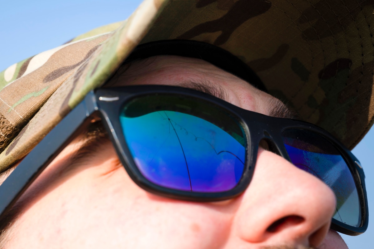 U.S. Air Force Staff Sgt. Daniel Meeks, 443rd Air Expeditionary Squadron client systems technician, inspects a communications antenna at Al Asad Air Base, Iraq, Dec. 11, 2022. In preparation for a squadron-wide technology refresh, Meeks has gone to each office to teach communication capabilities and skills to better smooth the transition for each individual. (U.S. Air Force photo by Staff Sgt. Dalton Williams)