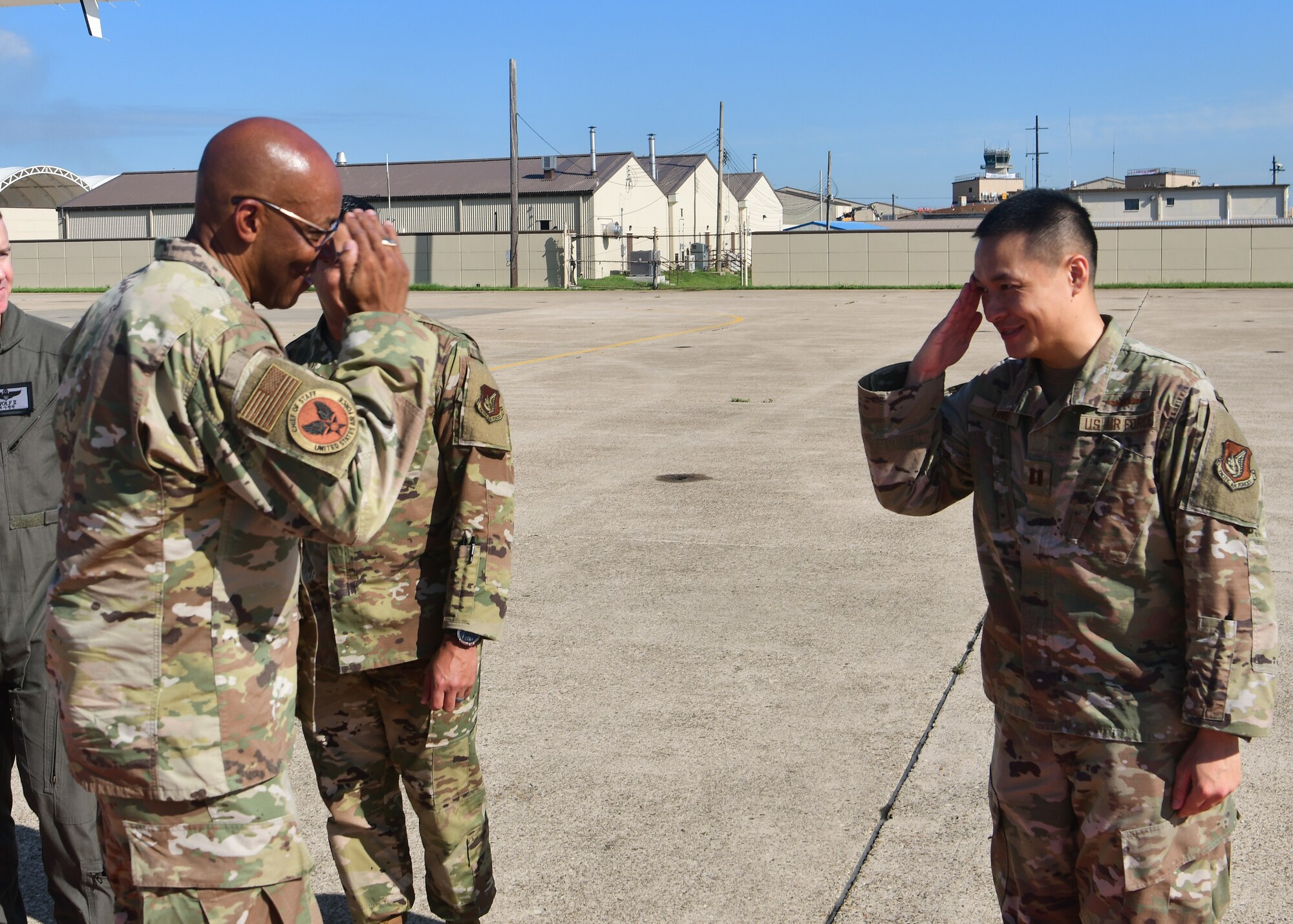 Airmen salute and greet one another.
