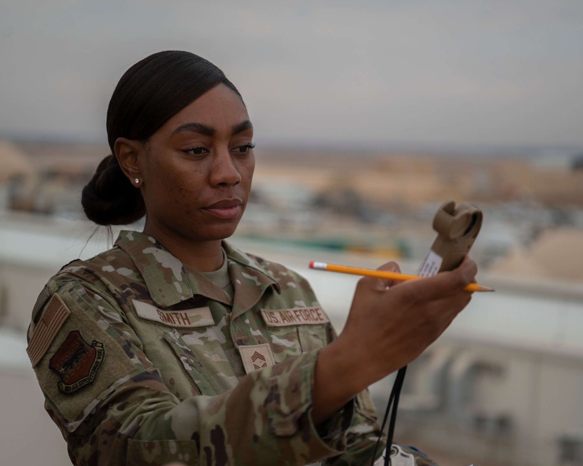 Chief Master Sgt. Keyonna Smith, Senior Enlisted Leader of 332d Air Expeditionary Wing A4 Logistics, operates a Kestrel 5500 Weather Meters at an undisclosed location, Southwest Asia, Nov. 2, 2022. Airmen with the 332d Expeditionary Operational Support Squadron use this device to measure wind velocity, temperature, humidity, dew point and elevation. (U.S. Air Force photo by: Tech. Sgt. Jeffery Foster)