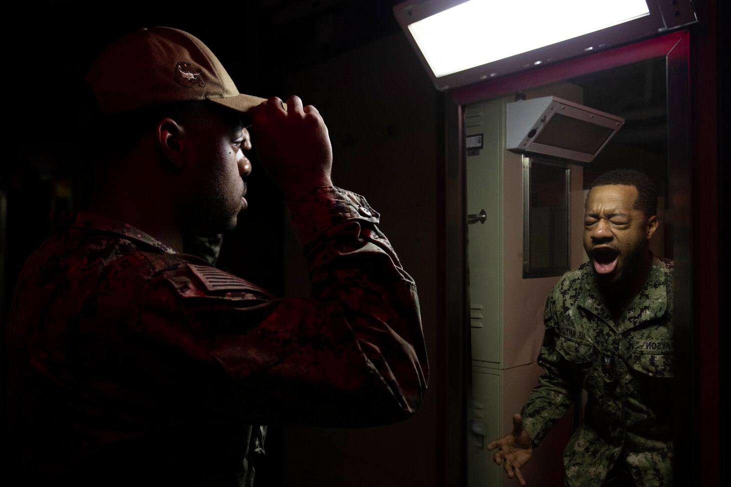 Sailor calmly puts on cover in front a mirror, but his reflection is screaming.