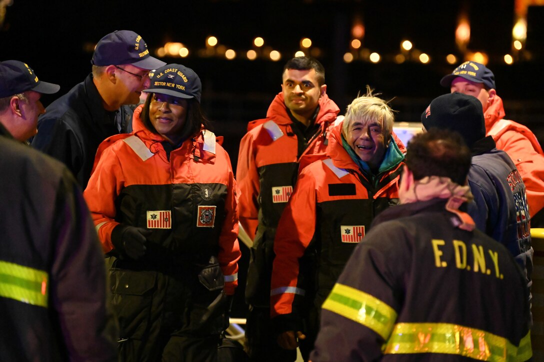 U.S. Coast Guard and FDNY members welcome rescued boaters and their rescuers to Coast Guard Station New York on Staten Island, New York, on Dec. 14, 2022. Kevin Hyde and Joe Ditomasso drifted on the sailboat Atrevida II for days along the East Coast without power or fuel before being rescued by the crew of the tanker vessel Silver Muna. (U.S. Coast Guard photo by Petty Officer 3rd Class John Hightower)