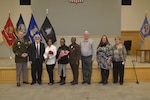 DLA Troop Support Commander Army Brig. Gen. Eric Shirley poses with retirees at a retirement ceremony Dec. 16 in Philadelphia. The seven retirees represent 293 years of government service.