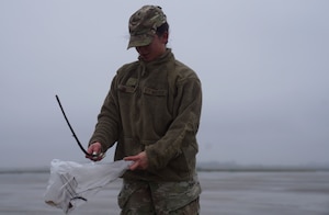 Airman 1st Class Natasha Hinestroza, 9th Munitions Squadron stockpile technician, picks up a branch during a foreign object debris (FOD) walk, Jan. 3, 2022, at Beale Air Force Base, Calif.