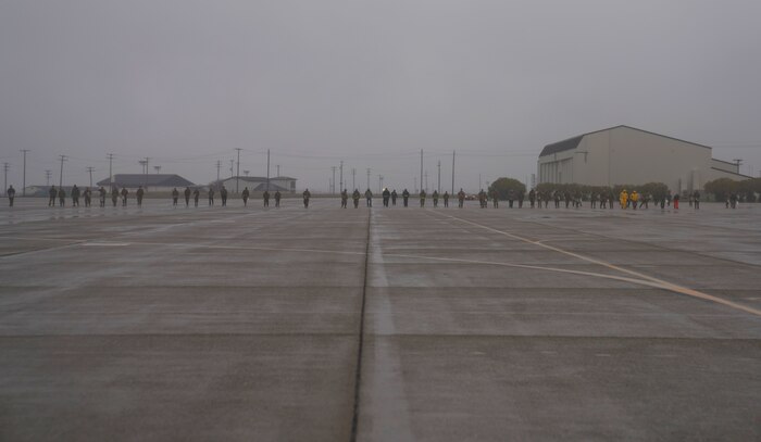Beale Airmen walk on the flightline conducting a foreign object debris (FOD) walk, Jan. 3, 2022, at Beale Air Force Base, Calif.