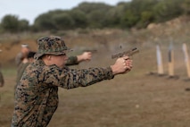 U.S. Marine Corps Lance Cpl. Aiden Lawson, a bulk fuel specialist, with 8th Engineer Support Battalion, Combat Logistics Regiment 27, 2nd Marine Logistics Group, and native of Maypearl, Texas, fires an M18 pistol during a pistol range at Naval Station Rota, Spain, December 11, 2022. Marines from II Marine Expeditionary Force rapidly deployed to Allied countries in order to foster strategic relationships and interoperability, support transatlantic security, and increase tactical proficiency in maritime environments. (U.S. Marine Corps photo by Sgt. Scott Jenkins)