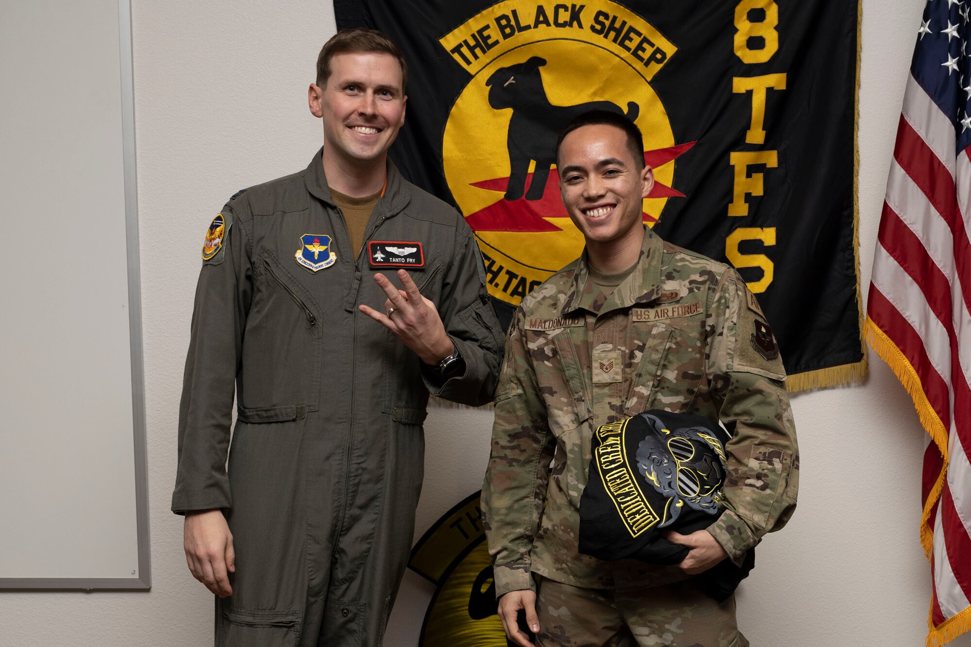 U.S. Air Force Staff Sgt. Brandon Maldonado, 8th Aircraft Maintenance Unit crew chief, right, poses for a photo with U.S. Air Force Capt. Thomas Fry, 8th Fighter Squadron pilot, during a Dedicated Crew Chief Appointment ceremony at Holloman Air Force Base, New Mexico, Jan. 3, 2022. To receive the title of DCC, a crew chief must demonstrate a history of superior performance in their career, comply with all safety practices and complete all required training. (U.S. Air Force photo by Senior Airman Antonio Salfran)