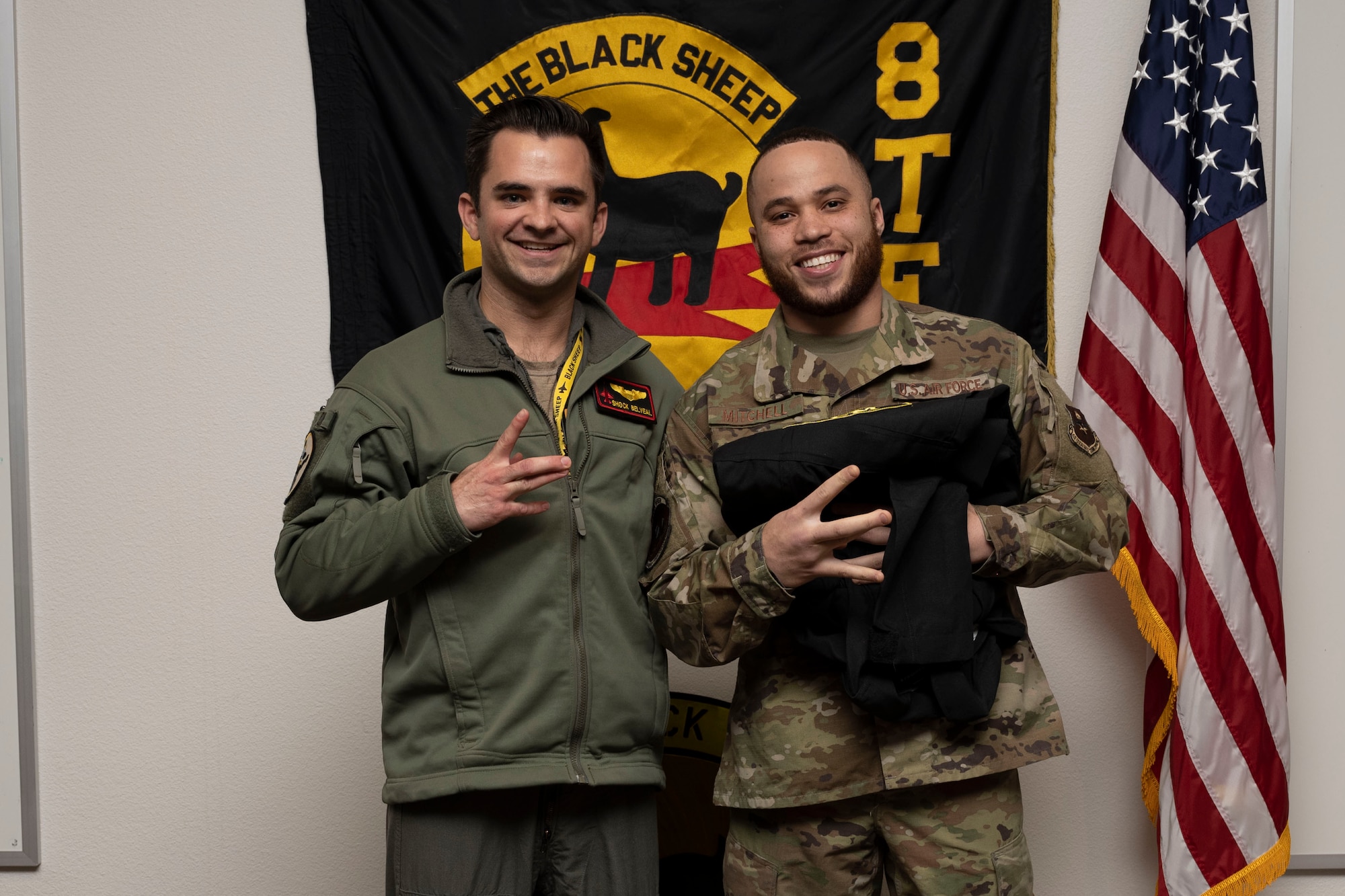 U.S. Air Force Senior Airman Alwayne Mitchell, 8th Aircraft Maintenance Unit crew chief, right, poses for a photo with U.S. Air Force Capt. Bradley Belveal, 8th Fighter Squadron pilot, during a Dedicated Crew Chief Appointment ceremony at Holloman Air Force Base, New Mexico, Jan. 3, 2022. To receive the title of DCC, a crew chief must demonstrate a history of superior performance in their career, comply with all safety practices and complete all required training. (U.S. Air Force photo by Senior Airman Antonio Salfran)