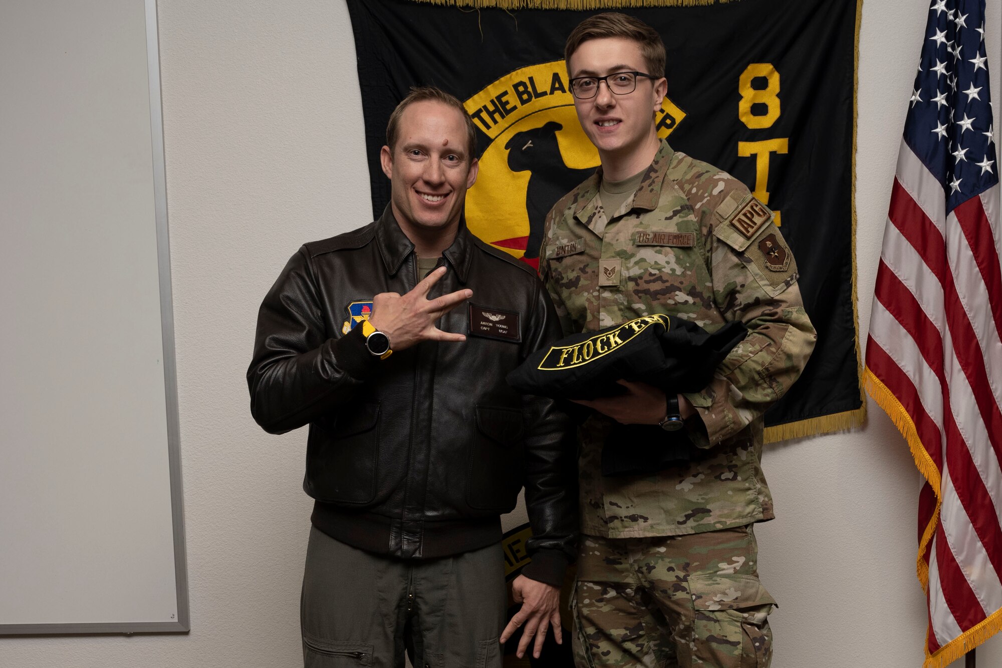 U.S. Air Force Staff Sgt. Cody Hinton, 8th Aircraft Maintenance Unit crew chief, right, poses for a photo with U.S. Air Force Maj. Aaron Young, 8th Fighter Squadron pilot, during a Dedicated Crew Chief Appointment ceremony at Holloman Air Force Base, New Mexico, Jan. 3, 2022. To receive the title of DCC, a crew chief must demonstrate a history of superior performance in their career, comply with all safety practices and complete all required training. (U.S. Air Force photo by Senior Airman Antonio Salfran)