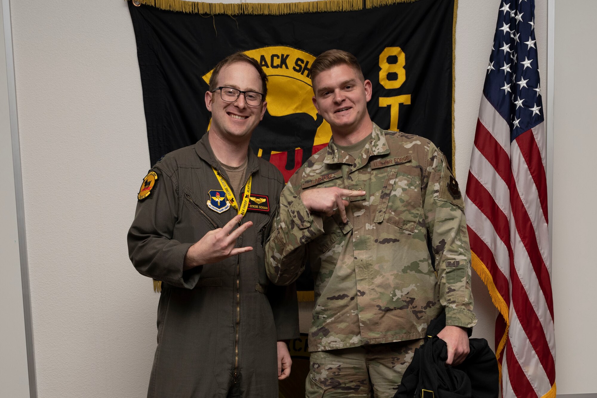 U.S. Air Force Staff Sgt. Ashton Carter, 8th Aircraft Maintenance Unit crew chief, right, poses for a photo with U.S. Air Force Capt. Nathaniel Dickman, 8th Fighter Squadron pilot, during a Dedicated Crew Chief Appointment ceremony at Holloman Air Force Base, New Mexico, Jan. 3, 2022. To receive the title of DCC, a crew chief must demonstrate a history of superior performance in their career, comply with all safety practices and complete all required training. (U.S. Air Force photo by Senior Airman Antonio Salfran)