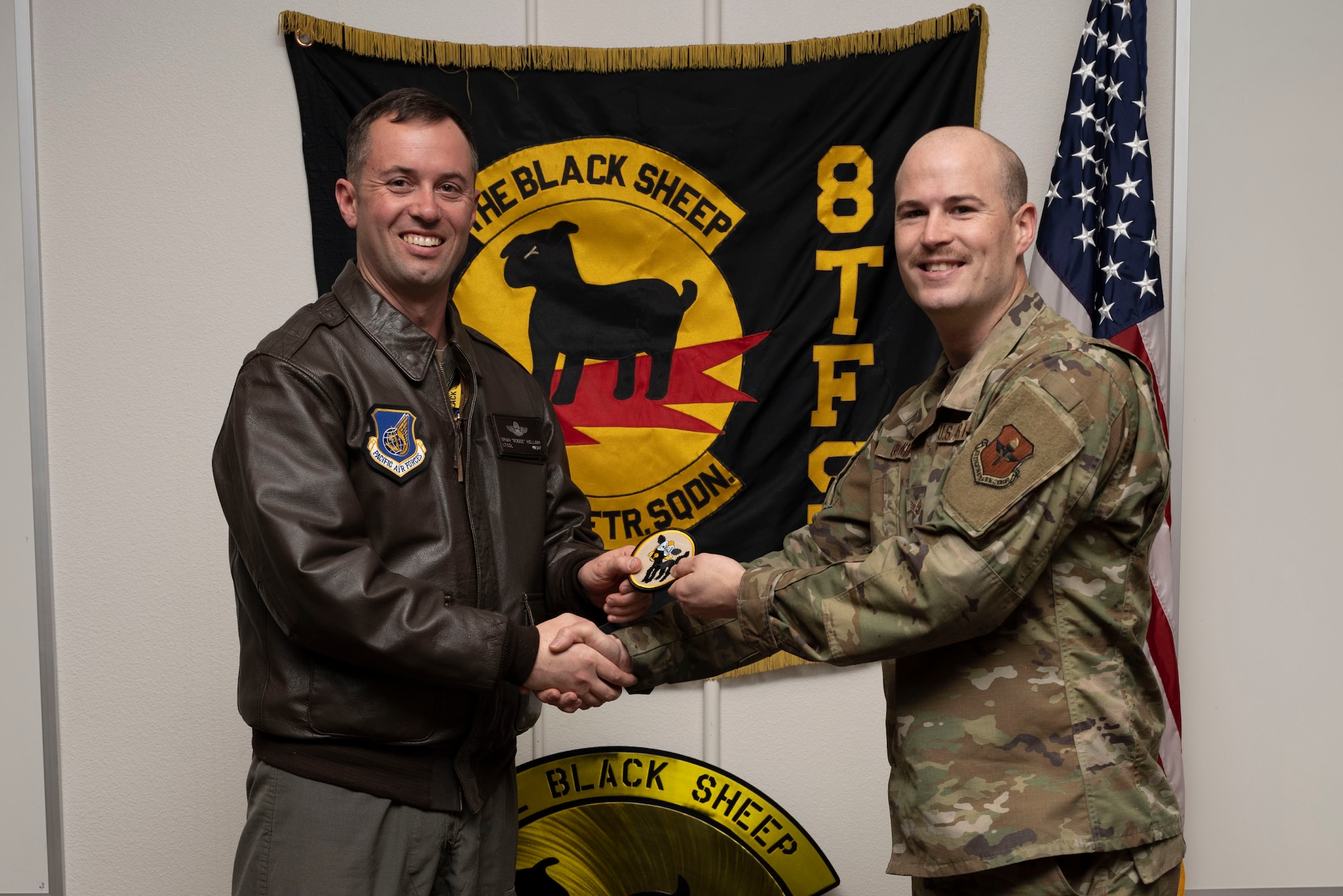 U.S. Air Force Senior Airman Holden Godwin, 8th Aircraft Maintenance Unit crew chief, right, poses for a photo with U.S. Air Force Lt. Col. Brian Kellam, 8th Fighter Squadron pilot, during a Dedicated Crew Chief Appointment ceremony at Holloman Air Force Base, New Mexico, Jan. 3, 2022. To receive the title of DCC, a crew chief must demonstrate a history of superior performance in their career, comply with all safety practices and complete all required training. (U.S. Air Force photo by Senior Airman Antonio Salfran)