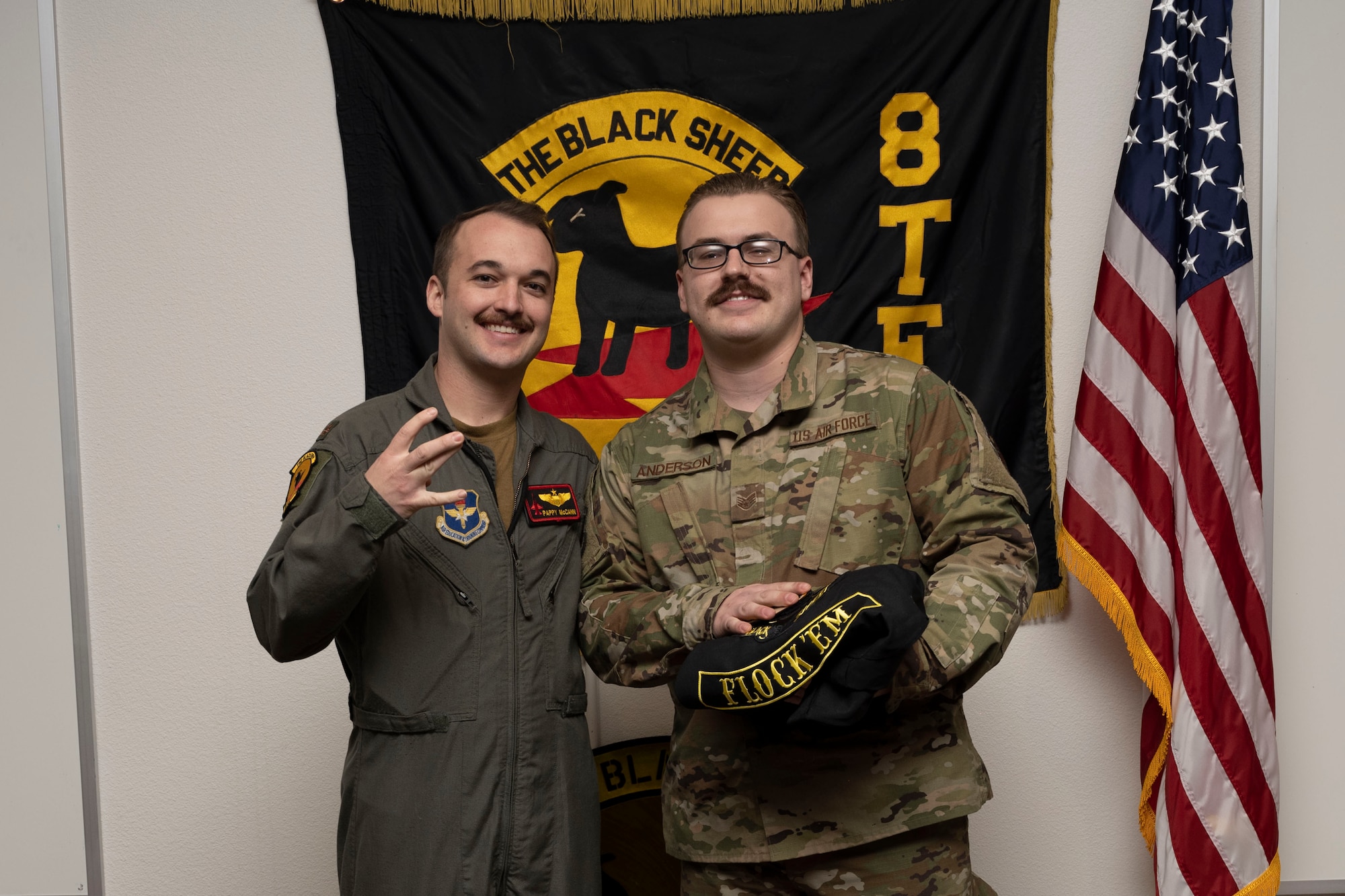 U.S. Air Force Staff Sgt. Isaac Anderson, 8th Aircraft Maintenance Unit crew chief, right, poses for a photo with U.S. Air Force Maj. Michael McCann, 8th Fighter Squadron pilot, during a Dedicated Crew Chief Appointment ceremony at Holloman Air Force Base, New Mexico, Jan. 3, 2022. To receive the title of DCC, a crew chief must demonstrate a history of superior performance in their career, comply with all safety practices and complete all required training. (U.S. Air Force photo by Senior Airman Antonio Salfran)