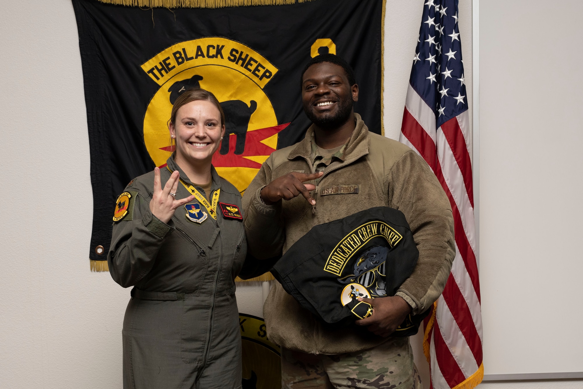 U.S. Air Force Staff Sgt. Shabaya Canada-Bannerman-Richter, 8th Aircraft Maintenance Unit crew chief, right, poses for a photo with U.S. Air Force Maj. Brittany Trimble, 8th Fighter Squadron pilot, during a Dedicated Crew Chief Appointment ceremony at Holloman Air Force Base, New Mexico, Jan. 3, 2022. To receive the title of DCC, a crew chief must demonstrate a history of superior performance in their career, comply with all safety practices and complete all required training. (U.S. Air Force photo by Senior Airman Antonio Salfran)