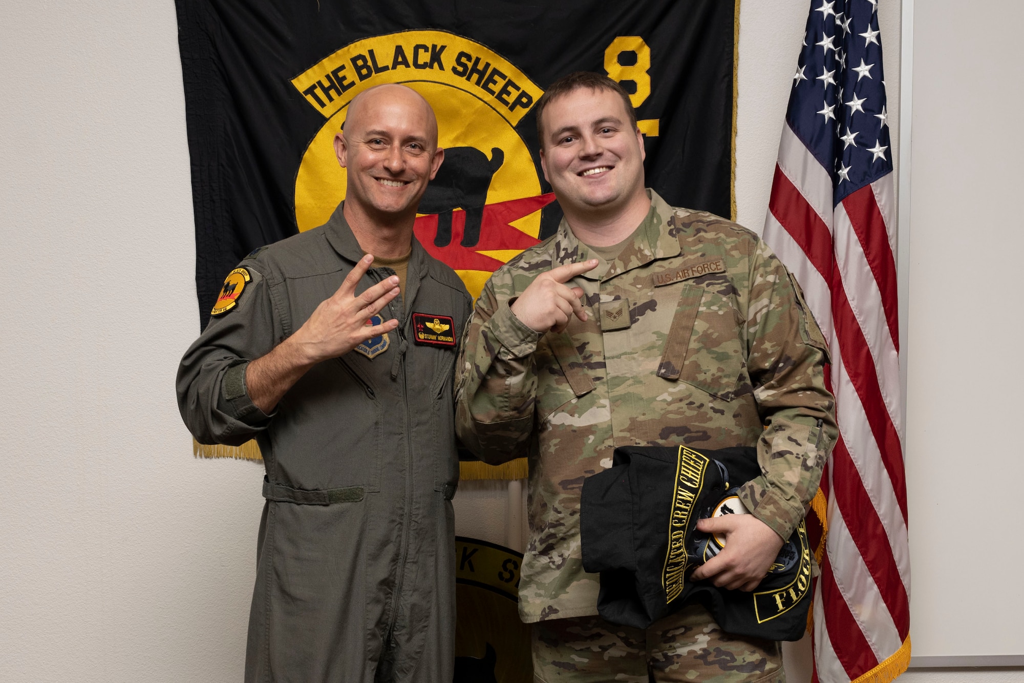 U.S. Air Force Senior Airman Samuel Allthoff, 8th Aircraft Maintenance Unit crew chief, right, poses for a photo with U.S. Air Force Lt. Col. George Normandin, 8th Fighter Squadron commander, during a Dedicated Crew Chief Appointment ceremony at Holloman Air Force Base, New Mexico, Jan. 3, 2022. To receive the title of DCC, a crew chief must demonstrate a history of superior performance in their career, comply with all safety practices and complete all required training. (U.S. Air Force photo by Senior Airman Antonio Salfran)