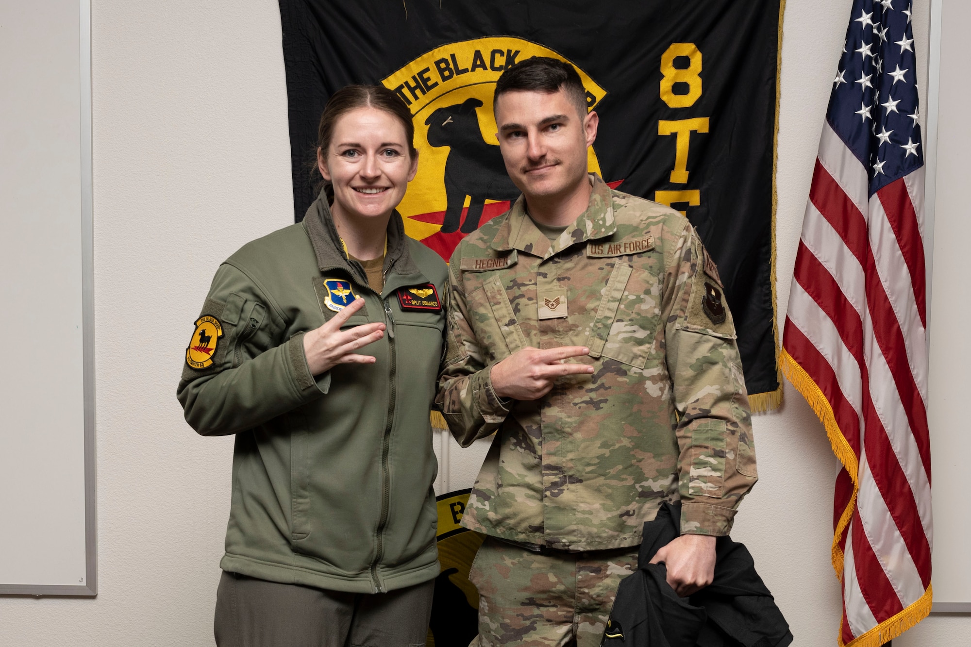 U.S. Air Force Staff Sgt. Wyatt Hegner, 8th Aircraft Maintenance Unit crew chief, right, poses for a photo with U.S. Air Force Capt. Ariel Demarzo, 8th Fighter Squadron pilot, during a Dedicated Crew Chief Appointment ceremony at Holloman Air Force Base, New Mexico, Jan. 3, 2022. To receive the title of DCC, a crew chief must demonstrate a history of superior performance in their career, comply with all safety practices and complete all required training. (U.S. Air Force photo by Senior Airman Antonio Salfran)