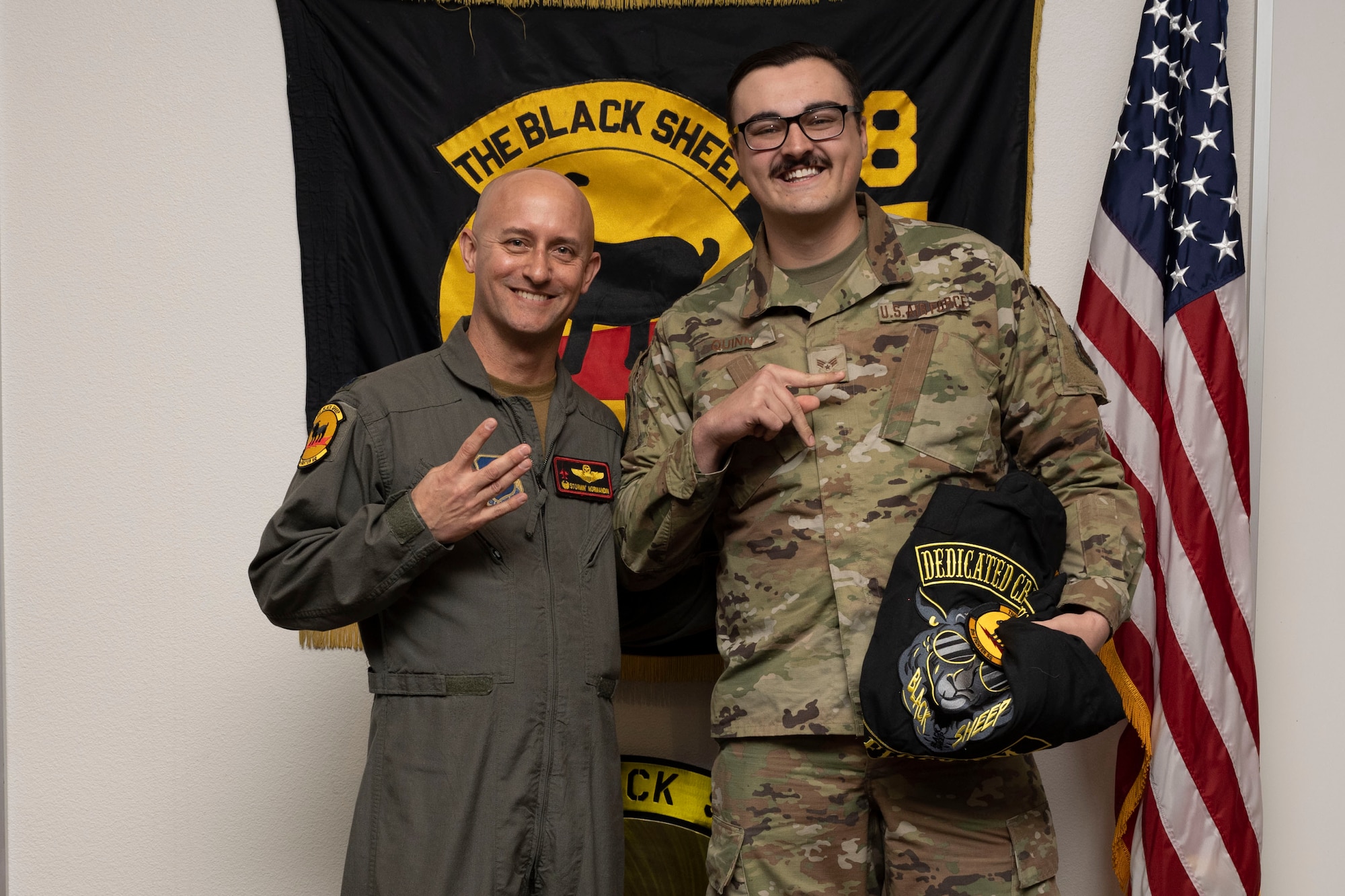 U.S. Air Force Senior Airman Thomas Quinn, 8th Aircraft Maintenance Unit crew chief, right, poses for a photo with U.S. Air Force Lt. Col. George Normandin, 8th Fighter Squadron commander, during a Dedicated Crew Chief Appointment ceremony at Holloman Air Force Base, New Mexico, Jan. 3, 2022. To receive the title of DCC, a crew chief must demonstrate a history of superior performance in their career, comply with all safety practices and complete all required training. (U.S. Air Force photo by Senior Airman Antonio Salfran)
