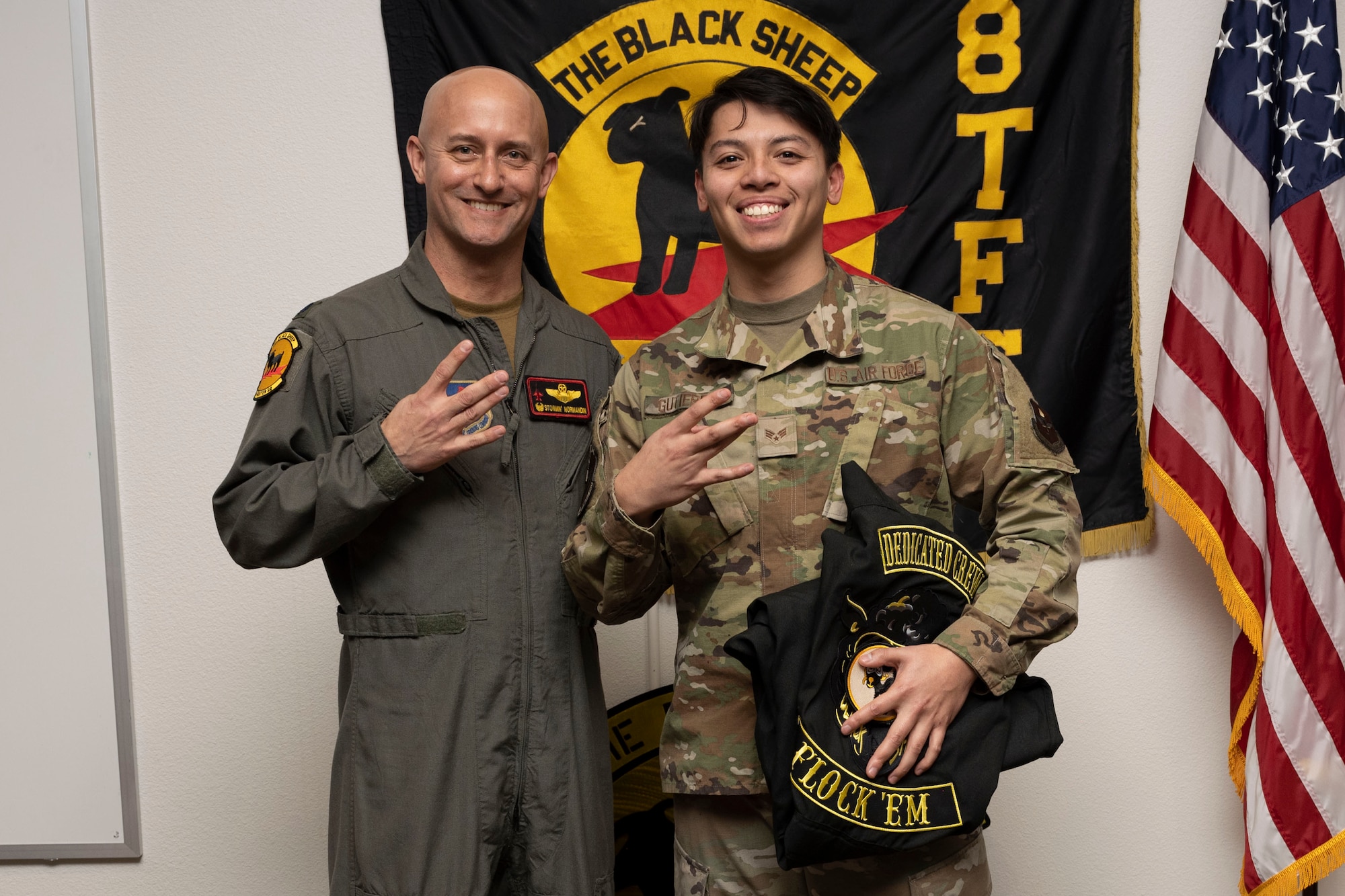 U.S. Air Force Senior Airman Anthony Gutierrez, 8th Aircraft Maintenance Unit crew chief, right, poses for a photo with U.S. Air Force Lt. Col. George Normandin, 8th Fighter Squadron commander, during a Dedicated Crew Chief Appointment ceremony at Holloman Air Force Base, New Mexico, Jan. 3, 2022. To receive the title of DCC, a crew chief must demonstrate a history of superior performance in their career, comply with all safety practices and complete all required training. (U.S. Air Force photo by Senior Airman Antonio Salfran)
