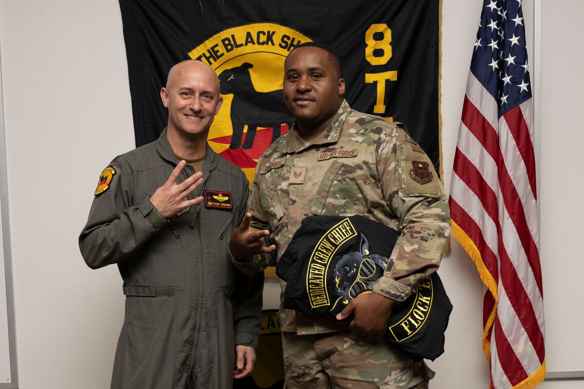 U.S. Air Force Staff Sgt. Parrish Burchett, 8th Aircraft Maintenance Unit crew chief, right, poses for a photo with U.S. Air Force Lt. Col. George Normandin, 8th Fighter Squadron commander, during a Dedicated Crew Chief Appointment ceremony at Holloman Air Force Base, New Mexico, Jan. 3, 2022. To receive the title of DCC, a crew chief must demonstrate a history of superior performance in their career, comply with all safety practices and complete all required training. (U.S. Air Force photo by Senior Airman Antonio Salfran)