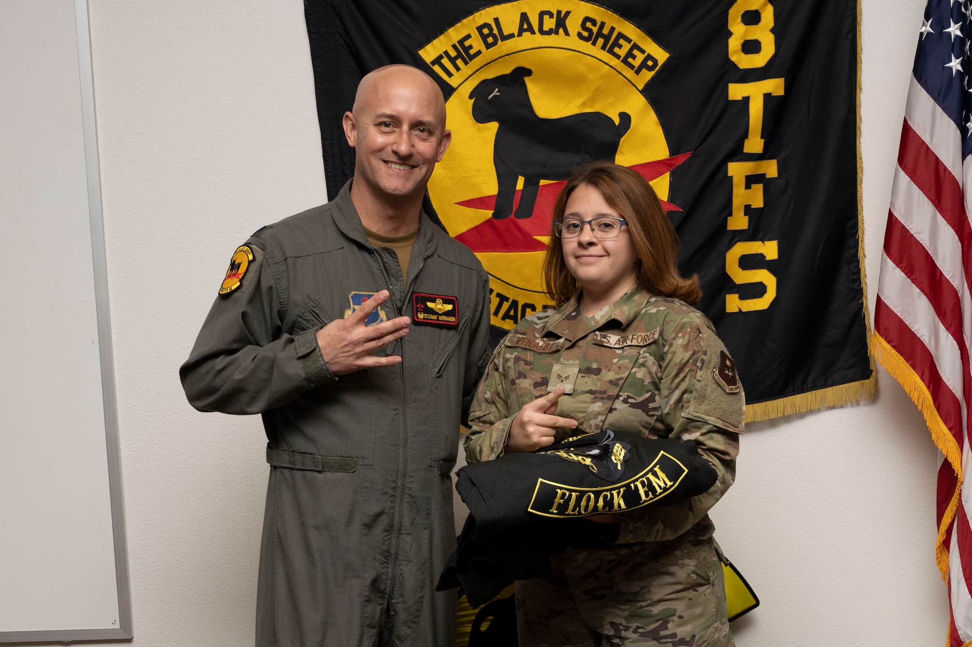 U.S. Air Force Senior Airman Alexis Veneble, 8th Aircraft Maintenance Unit crew chief, right, poses for a photo with U.S. Air Force Lt. Col. George Normandin, 8th Fighter Squadron commander, during a Dedicated Crew Chief Appointment ceremony at Holloman Air Force Base, New Mexico, Jan. 3, 2022. To receive the title of DCC, a crew chief must demonstrate a history of superior performance in their career, comply with all safety practices and complete all required training. (U.S. Air Force photo by Senior Airman Antonio Salfran)