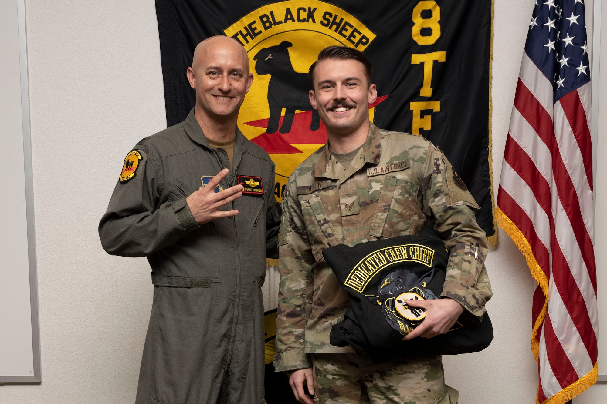 U.S. Air Force Staff Sgt. Alec Allen, 8th Aircraft Maintenance Unit crew chief, right, poses for a photo with U.S. Air Force Lt. Col. George Normandin, 8th Fighter Squadron commander, during a Dedicated Crew Chief Appointment ceremony at Holloman Air Force Base, New Mexico, Jan. 3, 2022. To receive the title of DCC, a crew chief must demonstrate a history of superior performance in their career, comply with all safety practices and complete all required training. (U.S. Air Force photo by Senior Airman Antonio Salfran)