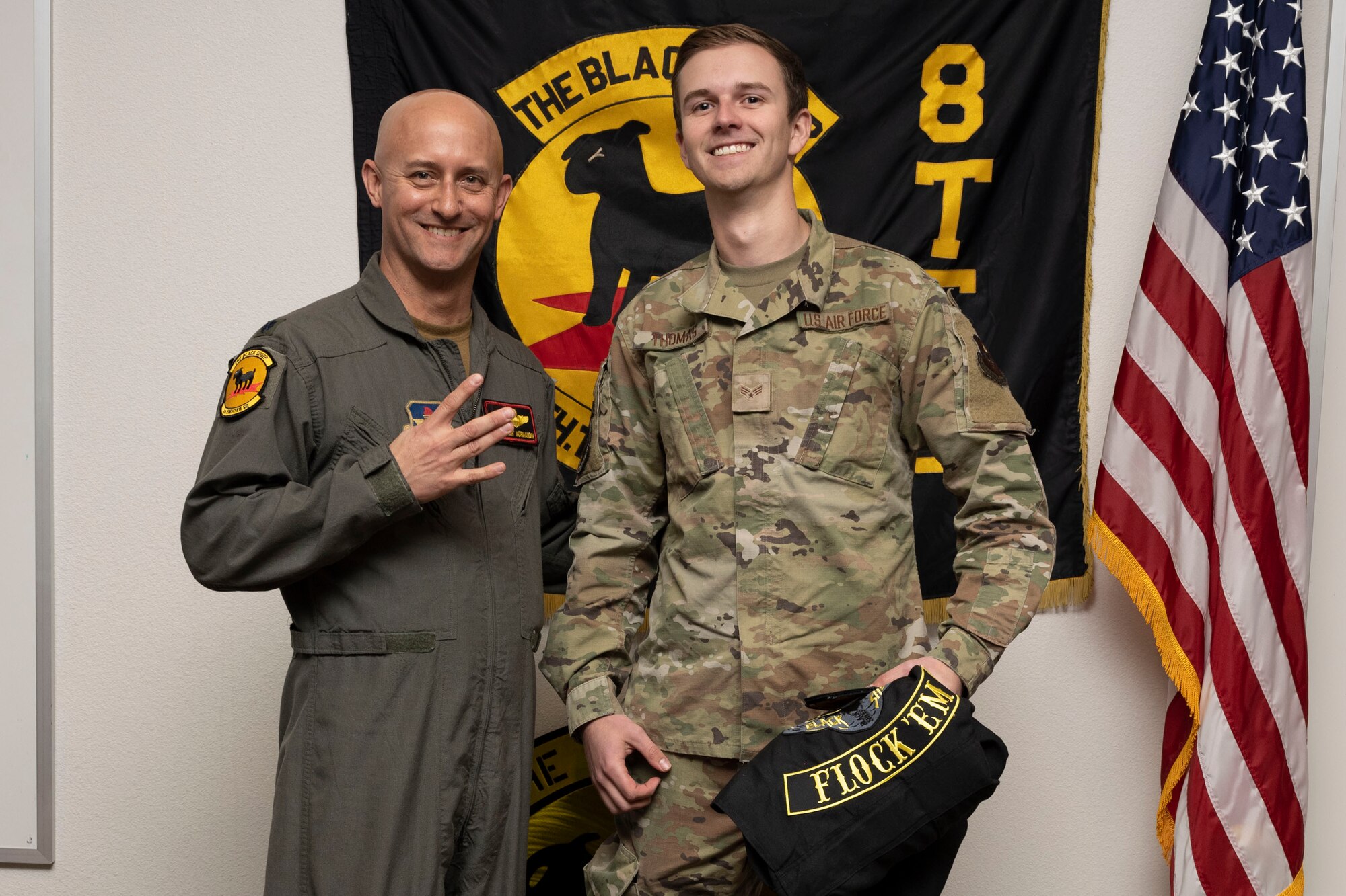 U.S. Air Force Senior Airman Dennis Thomas, 8th Aircraft Maintenance Unit crew chief, right, poses for a photo with U.S. Air Force Lt. Col. George Normandin, 8th Fighter Squadron commander, during a Dedicated Crew Chief Appointment ceremony at Holloman Air Force Base, New Mexico, Jan. 3, 2022. To receive the title of DCC, a crew chief must demonstrate a history of superior performance in their career, comply with all safety practices and complete all required training. (U.S. Air Force photo by Senior Airman Antonio Salfran)