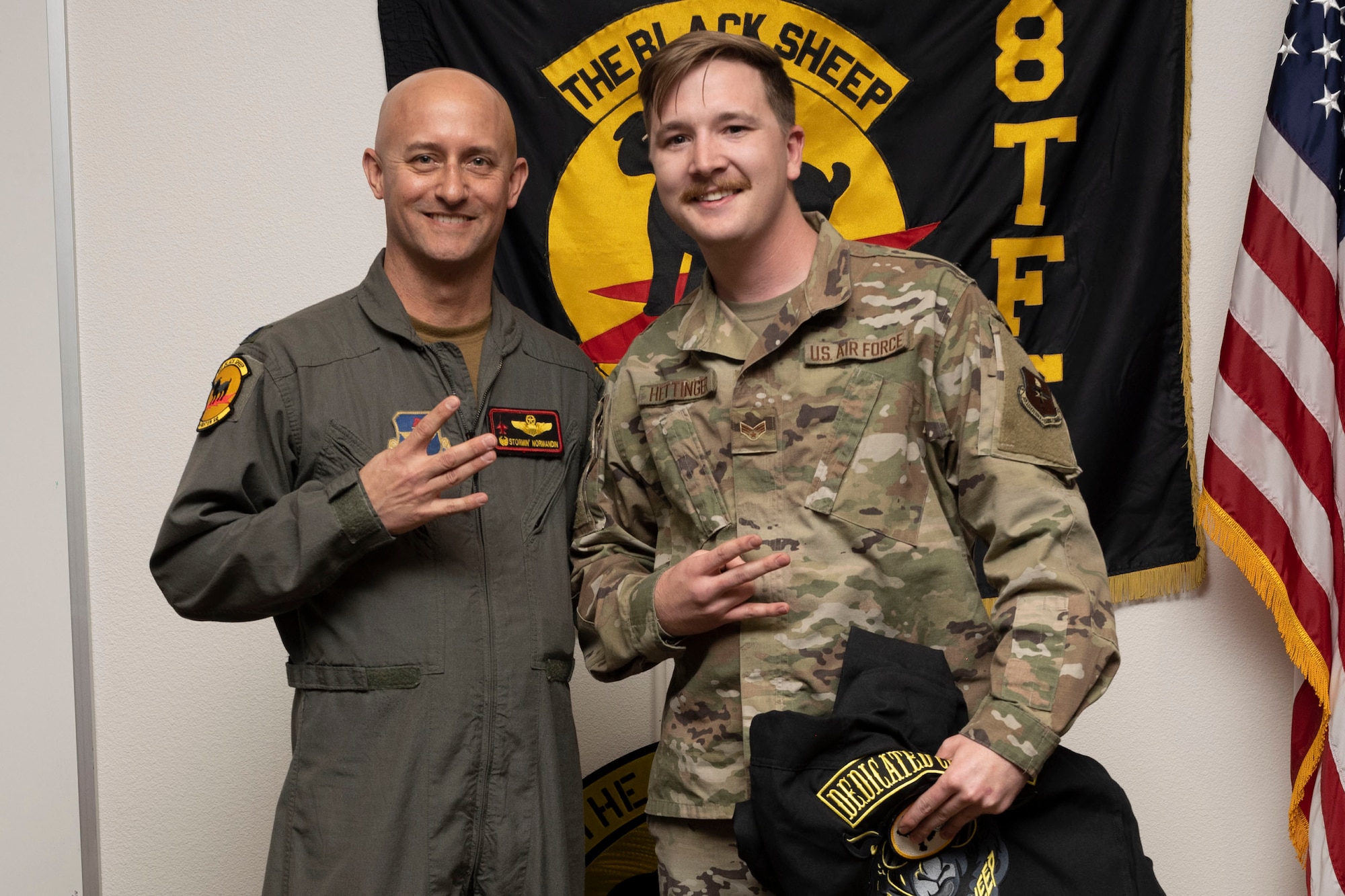 U.S. Air Force Senior Airman Brandon Hettinger, 8th Aircraft Maintenance Unit crew chief, right, poses for a photo with U.S. Air Force Lt. Col. George Normandin, 8th Fighter Squadron commander, during a Dedicated Crew Chief Appointment ceremony at Holloman Air Force Base, New Mexico, Jan. 3, 2022. To receive the title of DCC, a crew chief must demonstrate a history of superior performance in their career, comply with all safety practices and complete all required training. (U.S. Air Force photo by Senior Airman Antonio Salfran)