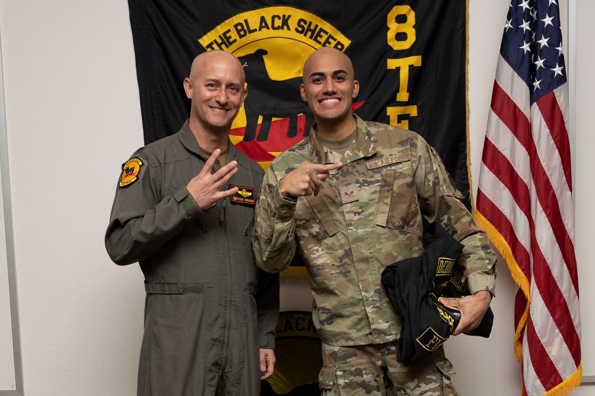 U.S. Air Force Senior Airman Damian Lopez, 8th Aircraft Maintenance Unit crew chief, right, poses for a photo with U.S. Air Force Lt. Col. George Normandin, 8th Fighter Squadron commander, during a Dedicated Crew Chief Appointment ceremony at Holloman Air Force Base, New Mexico, Jan. 3, 2022. To receive the title of DCC, a crew chief must demonstrate a history of superior performance in their career, comply with all safety practices and complete all required training. (U.S. Air Force photo by Senior Airman Antonio Salfran)