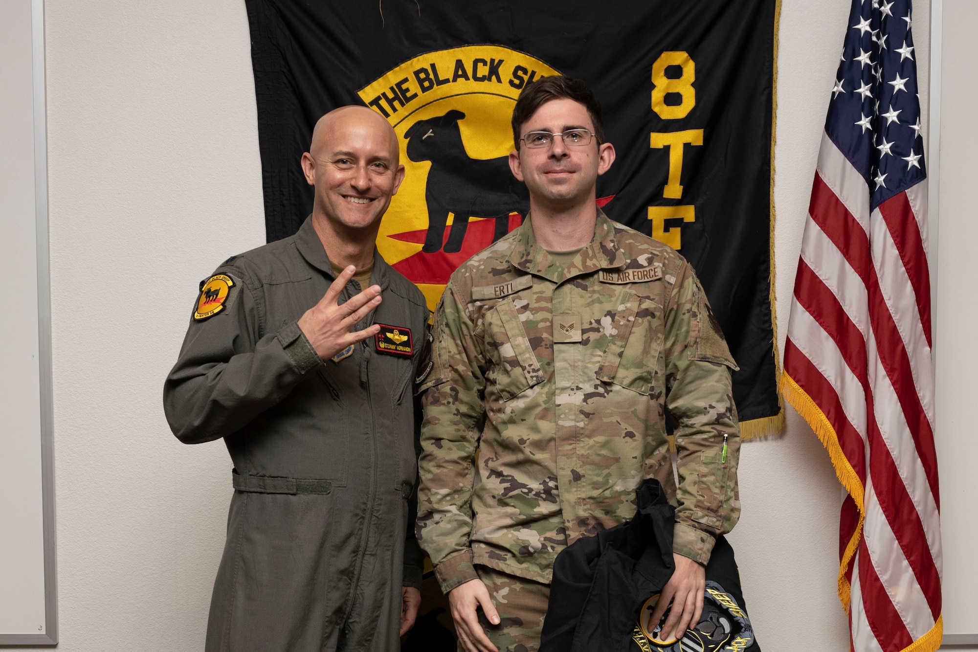 U.S. Air Force Senior Airman Luke Ertl, 8th Aircraft Maintenance Unit crew chief, right, poses for a photo with U.S. Air Force Lt. Col. George Normandin, 8th Fighter Squadron commander, during a Dedicated Crew Chief Appointment ceremony at Holloman Air Force Base, New Mexico, Jan. 3, 2022. To receive the title of DCC, a crew chief must demonstrate a history of superior performance in their career, comply with all safety practices and complete all required training. (U.S. Air Force photo by Senior Airman Antonio Salfran)