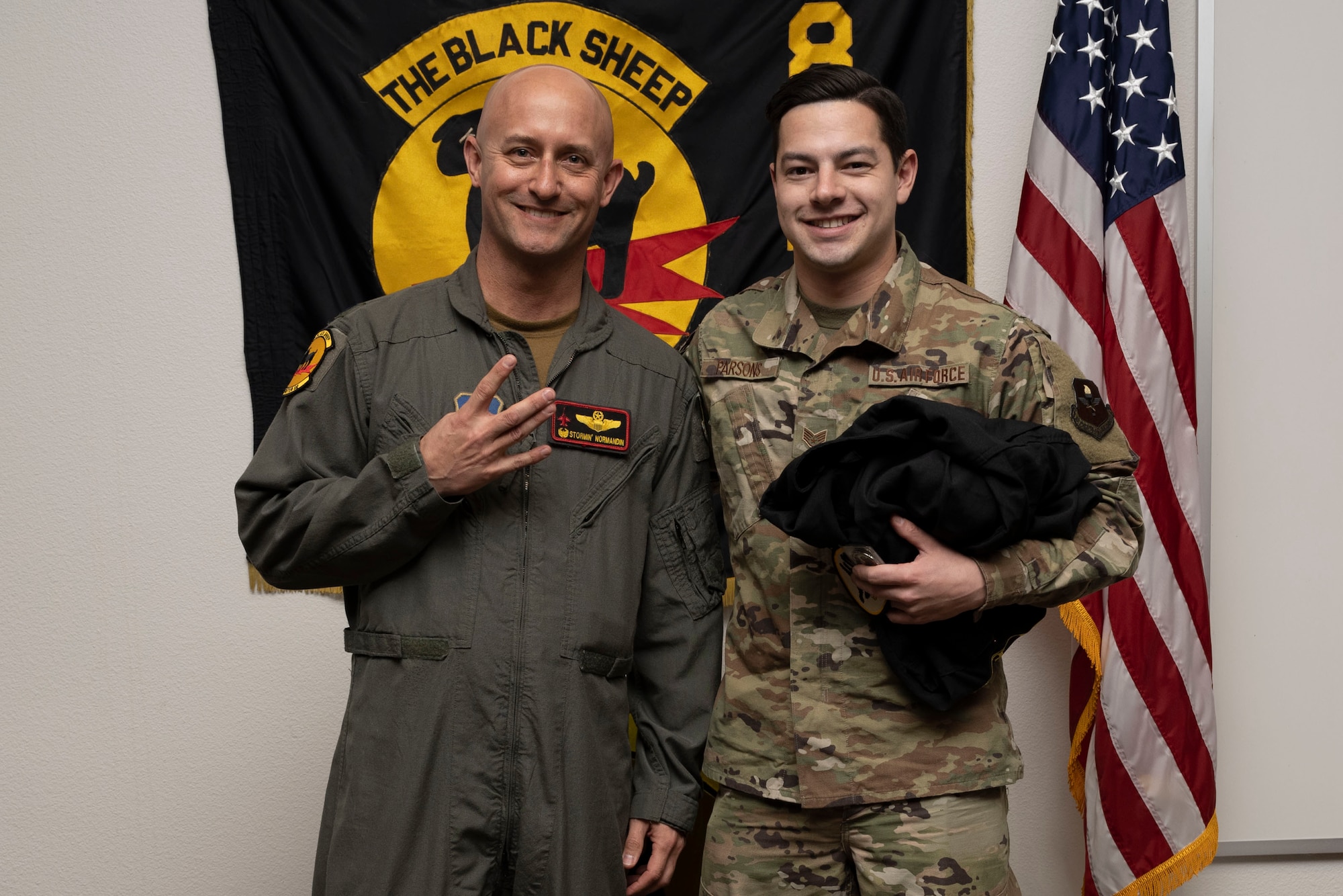 U.S. Air Force Staff Sgt. Connor Parsons, 8th Aircraft Maintenance Unit crew chief, right, poses for a photo with U.S. Air Force Lt. Col. George Normandin, 8th Fighter Squadron commander, during a Dedicated Crew Chief Appointment ceremony at Holloman Air Force Base, New Mexico, Jan. 3, 2022. To receive the title of DCC, a crew chief must demonstrate a history of superior performance in their career, comply with all safety practices and complete all required training. (U.S. Air Force photo by Senior Airman Antonio Salfran)