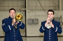 A photo of two men playing brass instruments.