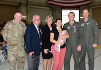 A group photo of a medal recipient and his family with 18th Air Force leadership.