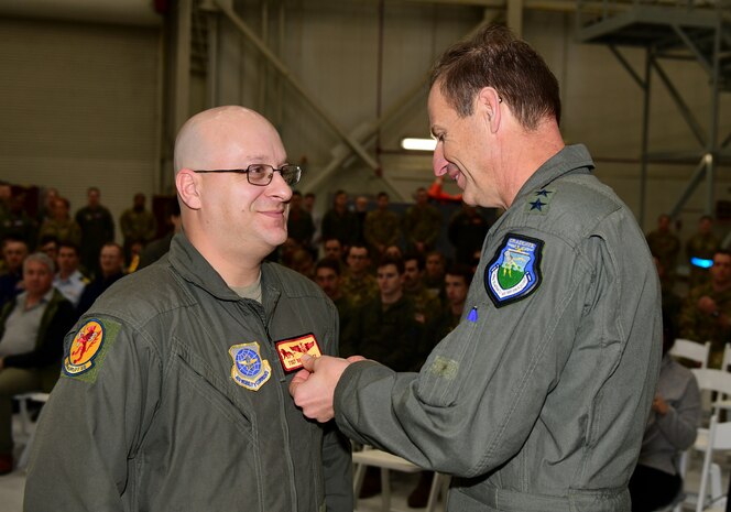 A photo of an Airman receiving a medal.