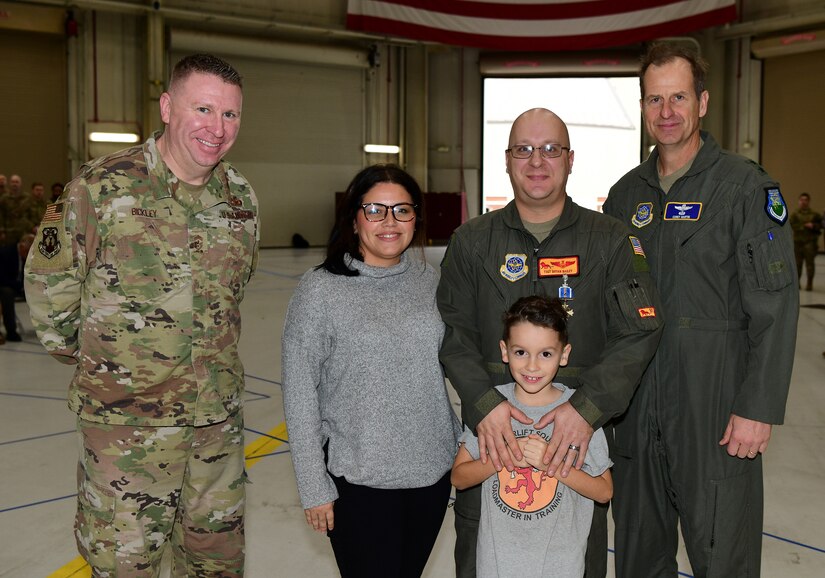 A group photo of a medal recipient and his family with 18th Air Force leadership.
