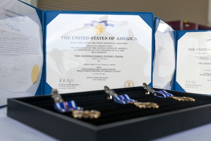 A photo of medals and certificates on a table.