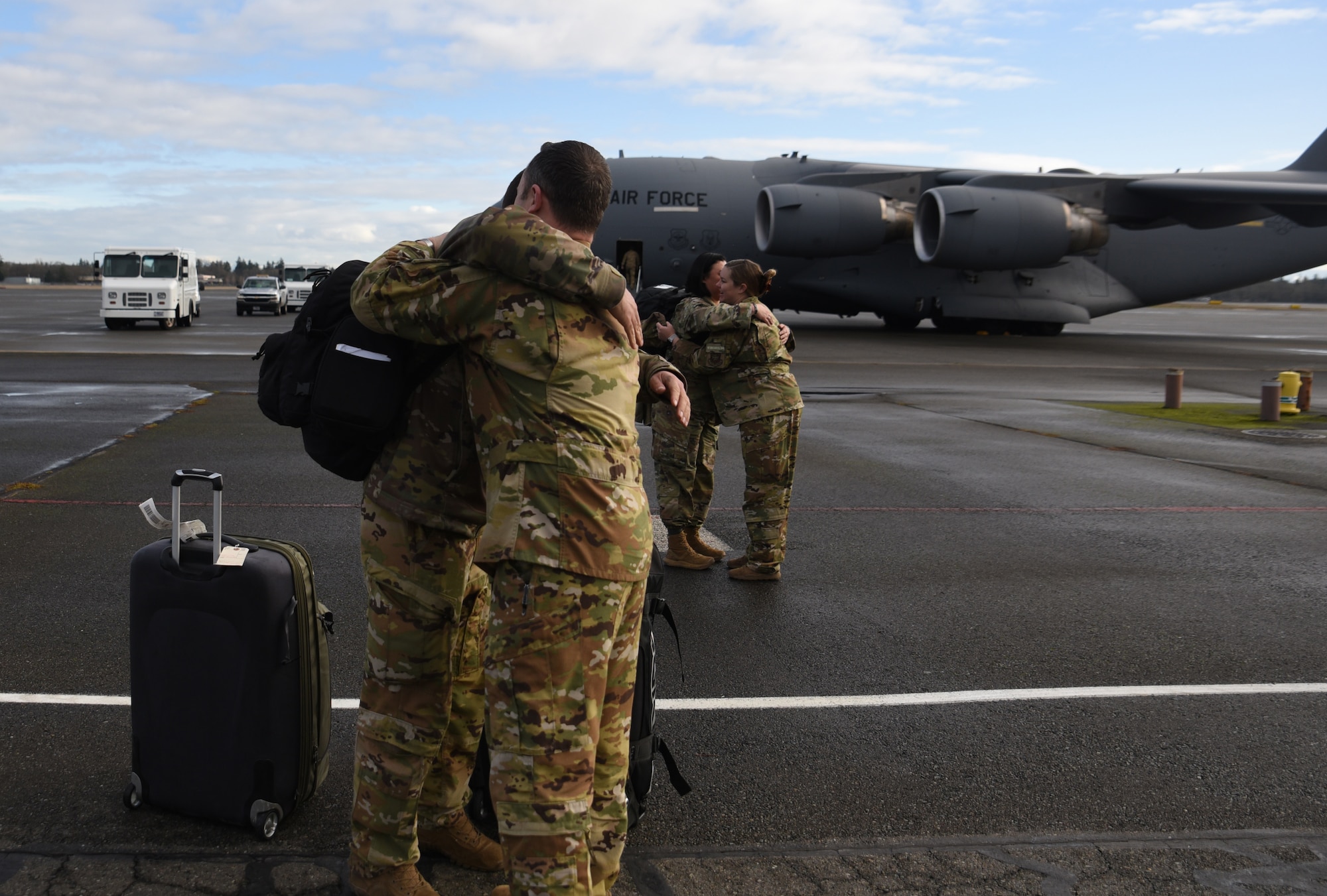 Team McChord Airmen reunite with friends and family after returning from their deployment at Joint Base Lewis-McChord, Washington, Jan. 3, 2023. Nearly two-dozen Airmen with the 8th Airlift Squadron reunited with their loved ones after being deployed for several months. (U.S. Air Force photo by Airman Kylee Tyus)
