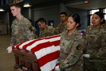 U.S. Army Soldiers with the California National Guard lift a casket during Cal Guard's Military Funeral Honors program week-long training course in San Diego Dec. 17, 2022. The Soldiers were trained by U.S. Army Staff Sgt. Zaira Robinson, the state trainer for the program, and seven are now fully certified to perform military funeral honors throughout California.