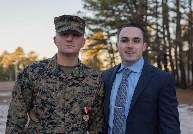 Alex LoRusso, one of the two victims of a car collision saved by Sgt. Joseph Howard, a Yonkers, New York native and an infantry mortarman with Weapons Company, 2nd Battalion, 25th Marine Regiment, 4th Marine Division, poses for a photo with Howard, at McGuire Air Force Base, New Jersey, Dec. 9, 2022. The Navy and Marine Corps Medal is the highest non-combatant decoration awarded. On Dec 30, 2017, at the time a lance corporal, Howard witnessed a car collision between four vehicles. Victims were trapped in a vehicle that had flipped eight times over a distance of 300 feet. Howard extracted the two unconscious victims from the car that continued to leak fuel. As he moved the second victim to safety, the vehicle was engulfed in flames and exploded. He then reassessed their injuries and provided life-saving first aid until first responders arrived. By his bold initiative and unwavering dedication to duty, Lance Cpl. Howard reflected great credit upon himself and upheld the highest traditions of the Marine Corps and United States Naval Service. LoRusso suffered severe life-threatening injuries but despite the circumstances he was able to recover and is now thriving.