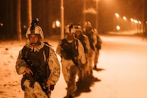 U.S. Marine Corps Sgt. Christine Latuner, platoon sergeant, with Combat Logistics Battalion 6 (CLB-6), Combat Logistics Regiment 2, 2nd Marine Logistics Group, leads her team during a patrol for Freezing Winds 22 Syndalen, Finland, Nov. 27, 2022. Task Force Red Cloud, headquartered by elements of CLB-6, is deployed to Finland in support of Exercises SYD 2022 and Freezing Winds 2022 to enhance U.S. and Finnish select interdependence in the maritime domain; solidify bilateral maritime maneuver within the Finnish littoral environment; and foster strong relationships between U.S. Marine Corps and Finnish Defense Force sustainment units. (U.S. Marine Corps photo by Cpl. Jackson Kirkiewicz)