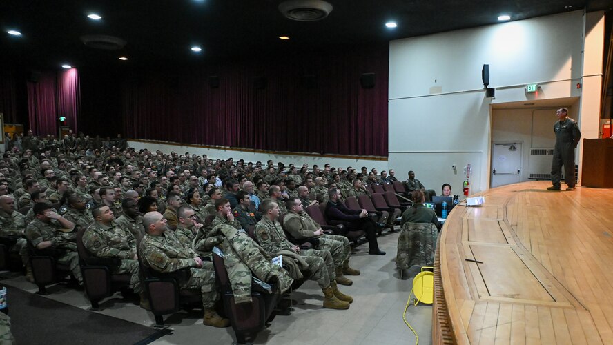 Col. Daniel Hoadley, 5th Bomb Wing commander, speaks at a 5 BW all-call Jan. 3, 2022 at Minot Air Force Base, North Dakota. Hoadley also informed Airmen of current and upcoming wing events and exercises, while also answering questions from the audience. (U.S. Air Force photo by Senior Airman Evan Lichtenhan)