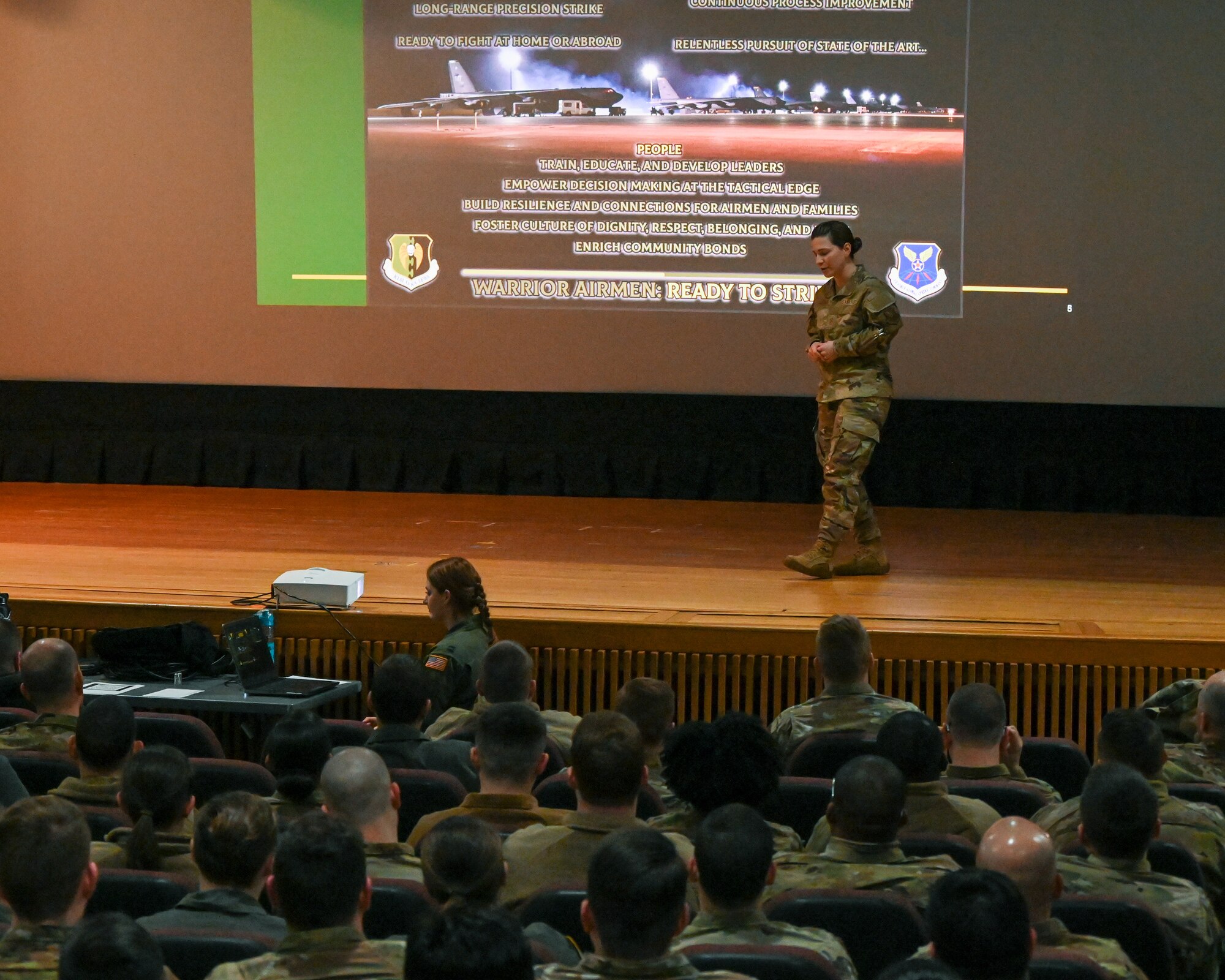 Col. Daniel Hoadley, 5th Bomb Wing commander, speaks at a 5 BW all-call Jan. 3, 2022 at Minot Air Force Base, North Dakota. Hoadley also informed Airmen of current and upcoming wing events and exercises, while also answering questions from the audience. (U.S. Air Force photo by Senior Airman Evan Lichtenhan)