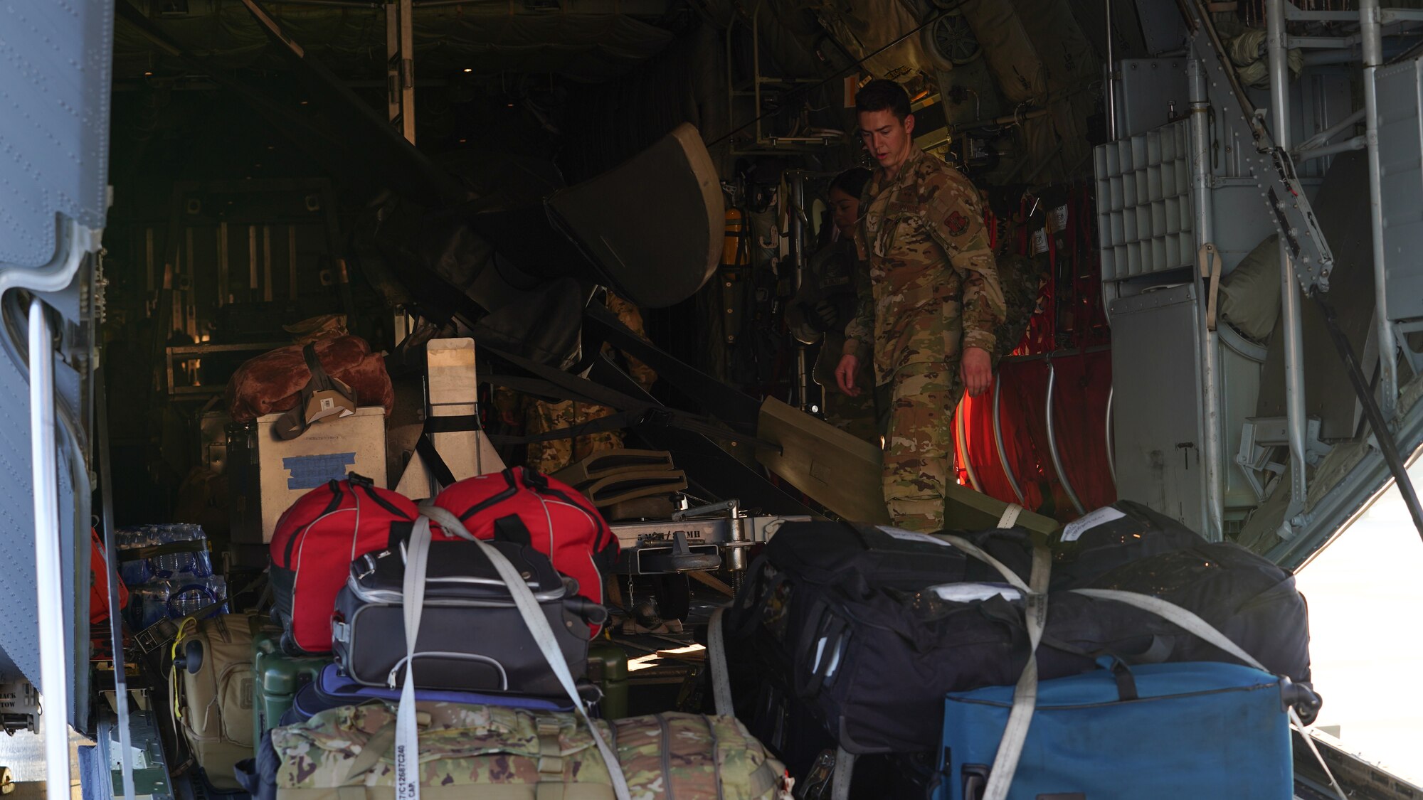 A U.S. Air Force Airman assigned to the 146th Airlift Wing loads a C-130J Hercules aircraft with the gear of deployers on Channel Islands Air National Guard Station Dec 3, 2022. The Airmen were deploying overseas for several months. (U.S. Air National Guard photo by Senior Airman Kalia Jenkins)