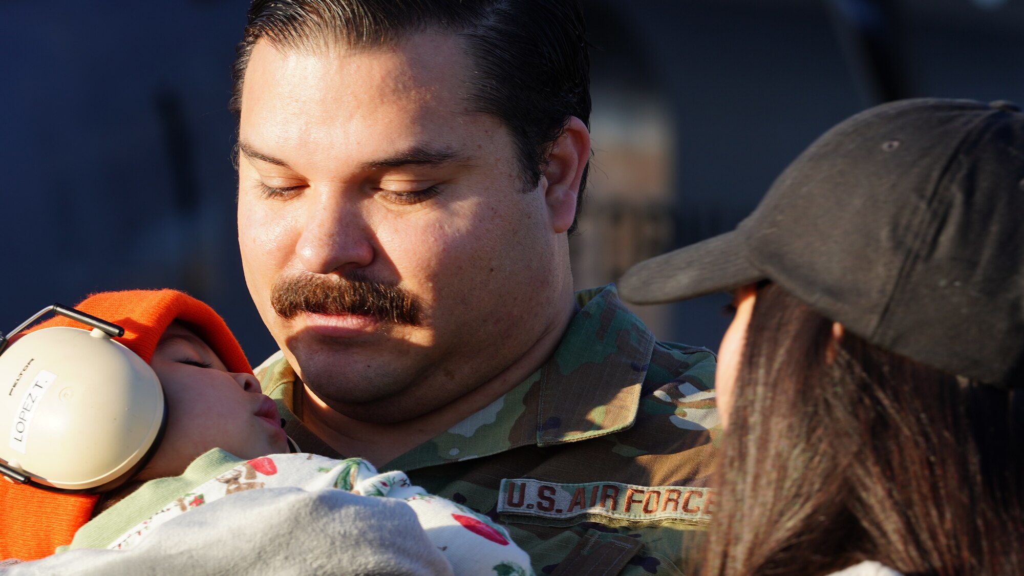 U.S. Air Force Airmen assigned to the 146th Airlift Wing say goodbye to friends and family before they load a C-130J Hercules aircraft on Channel Islands Air National Guard Station Dec 3, 2022. The Airmen were deploying overseas for several months. (U.S. Air National Guard photo by Senior Airman Kalia Jenkins)