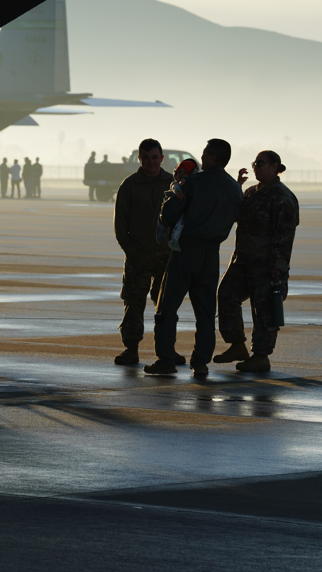 U.S. Air Force Airmen assigned to the 146th Airlift Wing say goodbye to friends and family before they load a C-130J Hercules aircraft on Channel Islands Air National Guard Station Dec 3, 2022. The Airmen were deploying overseas for several months. (U.S. Air National Guard photo by Senior Airman Kalia Jenkins)