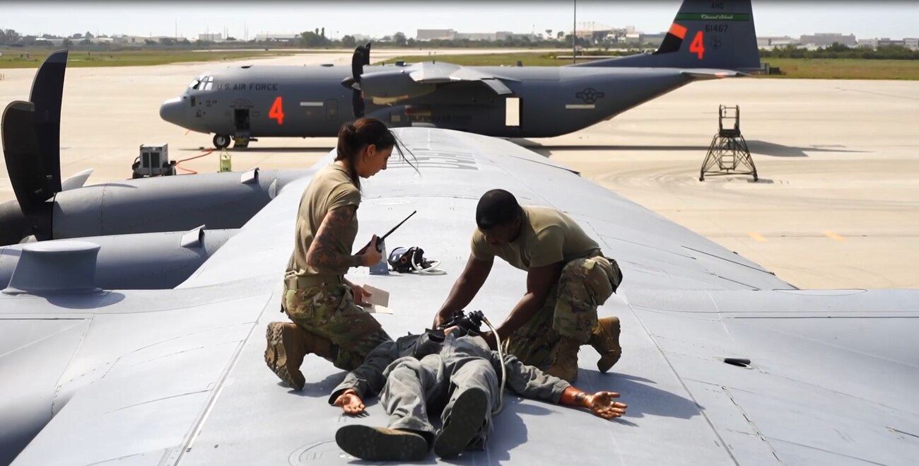 U.S. Air Force Master Sgt. Eddie Thomas and Airman 1st Class Nicole Centeno, assigned to the 146th Maintenance Squadron strap an oxygen mask onto a mannequin during an exercise September 9, 2022 at the Channels Islands Air National Guard Station, Port Hueneme, California. The 146th Airlift Wing participated in an annual Emergency Extraction Exercise to complete certification requirements for confined space rescue. (U.S. Air National Guard photo by Staff Sgt. Nicole Wright)