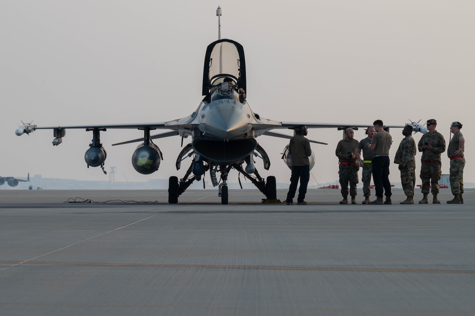 U.S. Air Force Airman prepare a F-16 Fighting Falcon for a ground aircraft to aircraft refuel