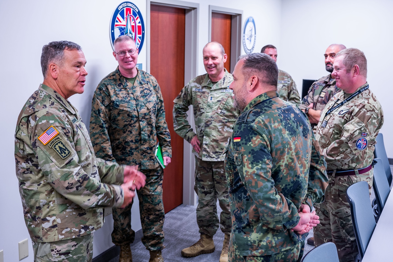 U.S. Army Gen. James Dickinson, United States Space Command (USSPACECOM) commander, left, and U.S. Marine Corps Master Gunnery Sgt. Scott Stalker, USSPACECOM command senior enlisted leader, second from left, speak with liaison officers from multiple nations while visiting the Combined Force Space Component Command (CFSCC) at Vandenberg Space Force Base, Calif., Jan. 4, 2023. CFSCC plans, tasks, directs, monitors, and assess the execution of combined and joint space operations for theater effects on behalf of the USSPACECOM command to directly integrate with ongoing operations in other Combatant Commands. USSPACECOM conducts operations in, from, and to space to deter conflict, and if necessary, defeat aggression, deliver space combat power for the Joint and Combined force, and defend U.S. vital interests with allies and partners. (U.S. Space Force photo by Tech. Sgt. Luke Kitterman)