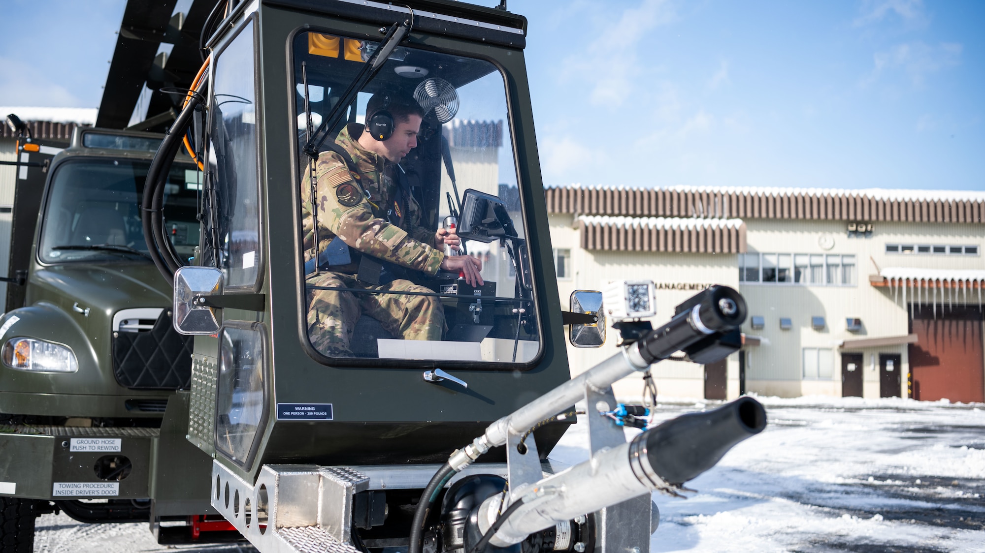 U.S. Airmen assigned to the 35th Logistics Readiness Squadron operate an extended deicer at Misawa Air Base, Japan, Dec. 20, 2022. After the primary deicer broke down beyond repair, 35th Logistics Readiness Squadron members coordinated the arrival of a new deicer to resume the mission of clearing off Misawa Air Bases’ F-16 Fighting Falcons. (U.S. Air Force photo by Staff Sgt. Kristen Heller)
