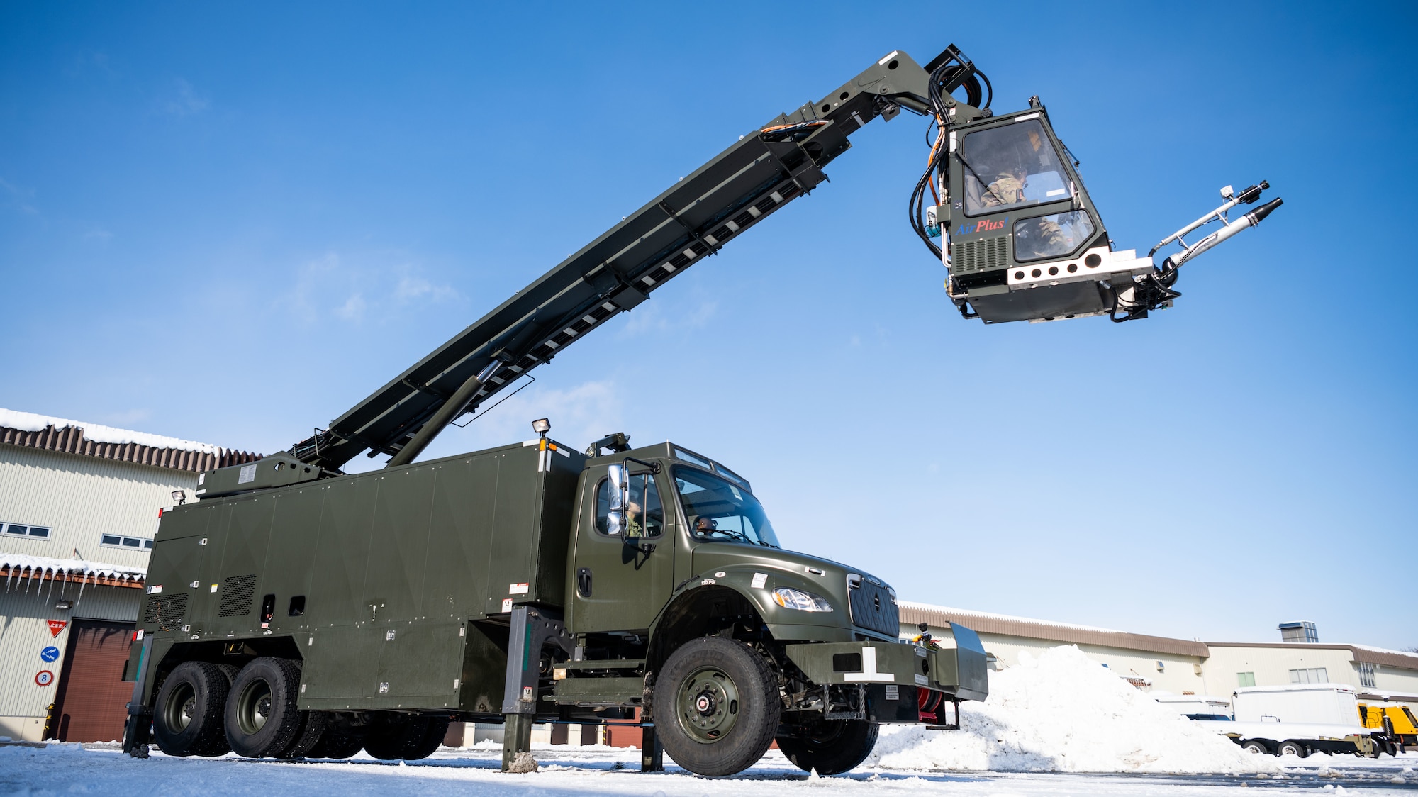 U.S. Airmen assigned to the 35th Logistics Readiness Squadron operate an extended deicer at Misawa Air Base, Japan, Dec. 20, 2022. After the primary deicer broke down beyond repair, 35th Logistics Readiness Squadron members coordinated the arrival of a new deicer to resume the mission of clearing off Misawa Air Bases’ F-16 Fighting Falcons. (U.S. Air Force photo by Staff Sgt. Kristen Heller)