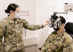 A Soldier with U.S. Army Health Clinic Baumholder performs an eye examination on a Soldier with the 44th Expeditionary Signal Battalion-Enhanced, 2nd Theater Signal Brigade, during a medical readiness rodeo at USAHC Baumholder, Dec. 12. The event assembled individual medical readiness elements to expedite annual medical requirements for Soldiers with the 44th ESB-E.