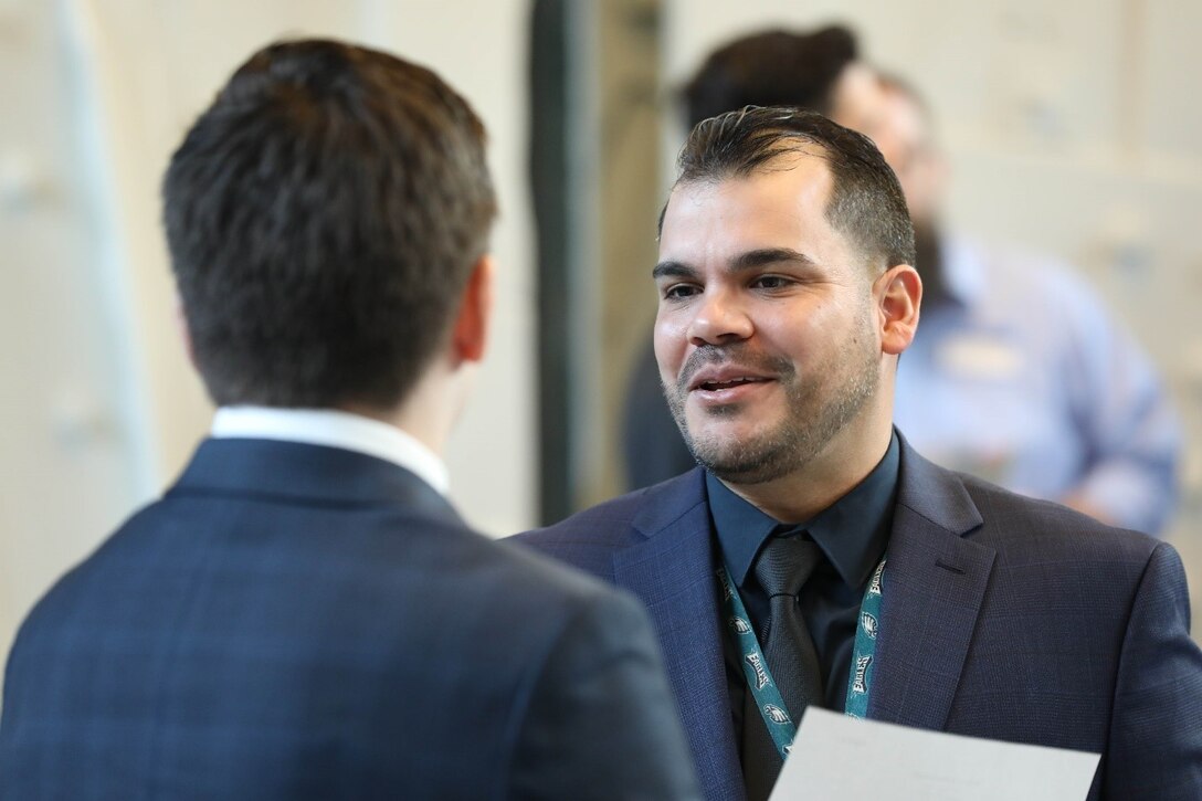 Naval Surface Warfare Center, Philadelphia Division Technology Deployment Branch manager  Jose Rosario speaks with a potential candidate during the NSWCPD career fair at Penn State on the Navy Yard in Philadelphia on Dec. 14, 2022. Career fairs are important to the Navy because they help fill vital positions. (U.S. Navy photo by Sgt. Jermaine Sullivan/Released)